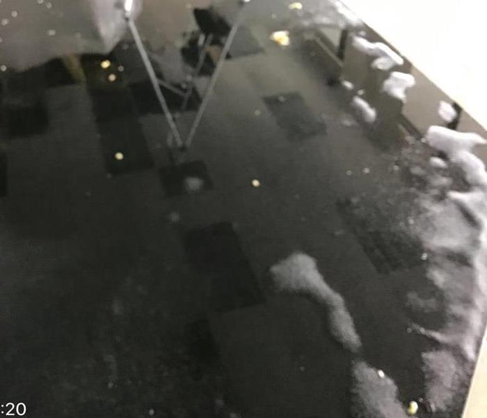 Standing water after roof damage at local business